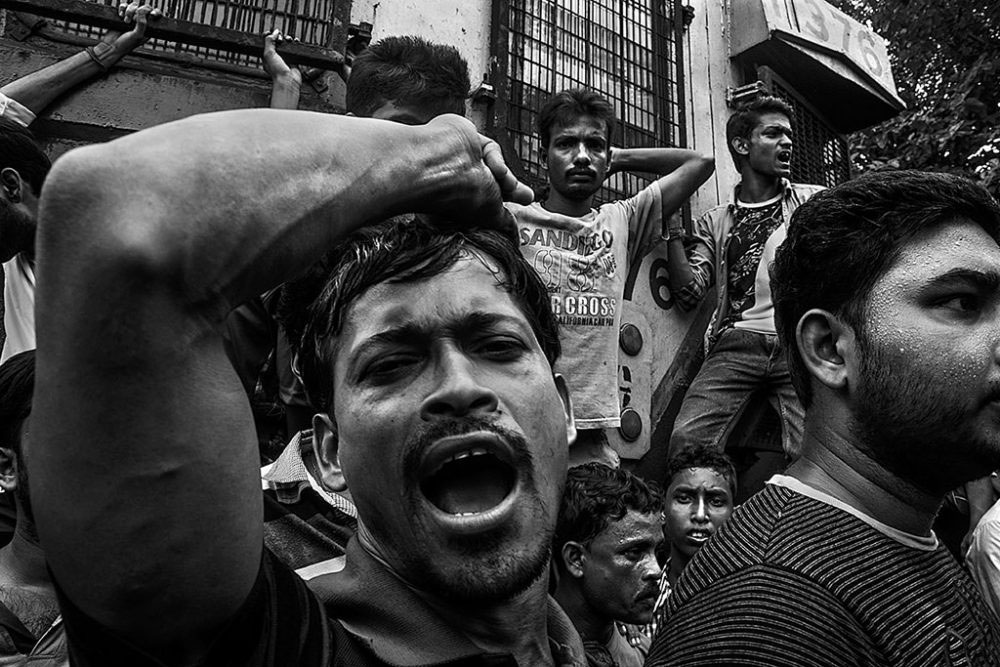 Birati, Kolkata, India - 19th August 2015. People, waiting for the next train, joined with the co-male passengers of ladies special train and were rising their voice with slogans.