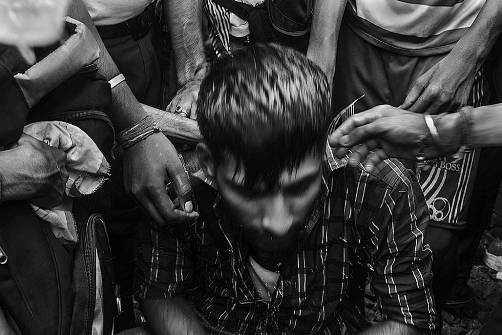 Birati, Kolkata, India - 19th August 2015. Few people among the mass sprinkled water on a young protester's face who sat down in between the running mass, as no such proper step lodged against the accused lady who threw the grandfather along with his grandson.