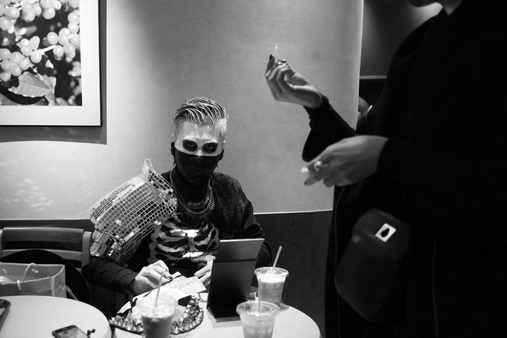 TOKYO, JAPAN - October 2015. Young man prepares his Halloween costume in restaurant.