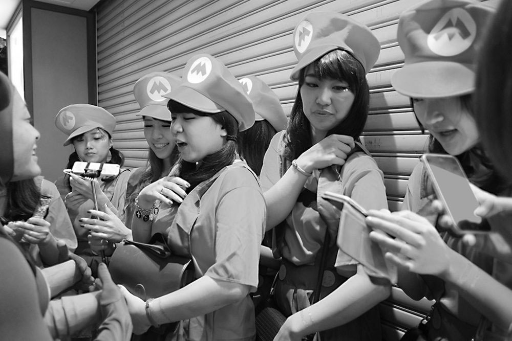 TOKYO, JAPAN - October 2015. Halloween street party girls dressed as Mario Bros.