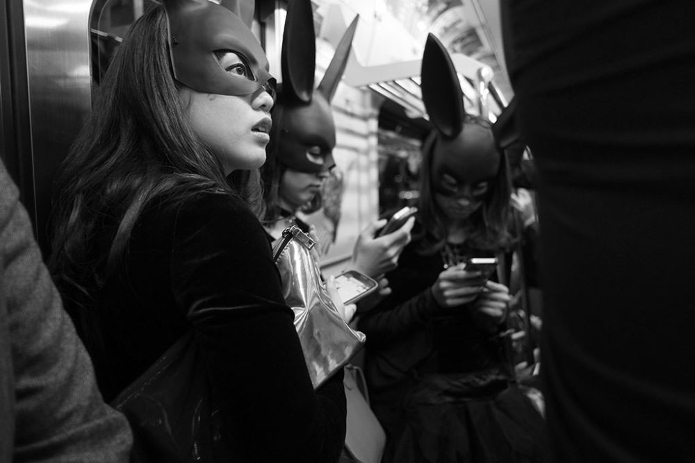 TOKYO, JAPAN - October 2015. Bat-women returning home after Halloween party.