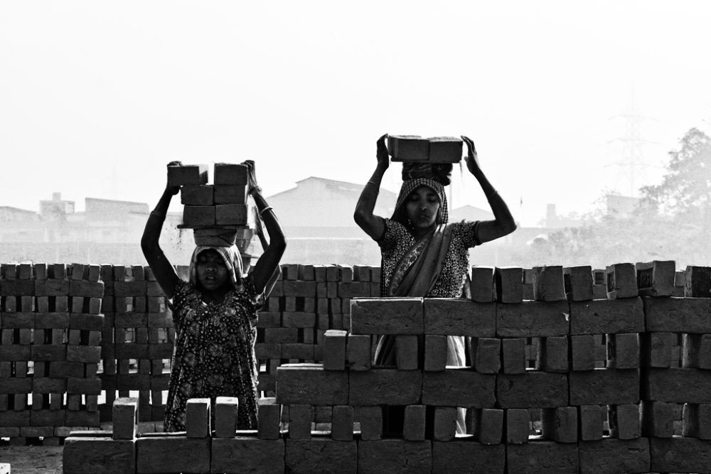 Kolkata, India- February 2016. Transferring the bricks toward the kiln.