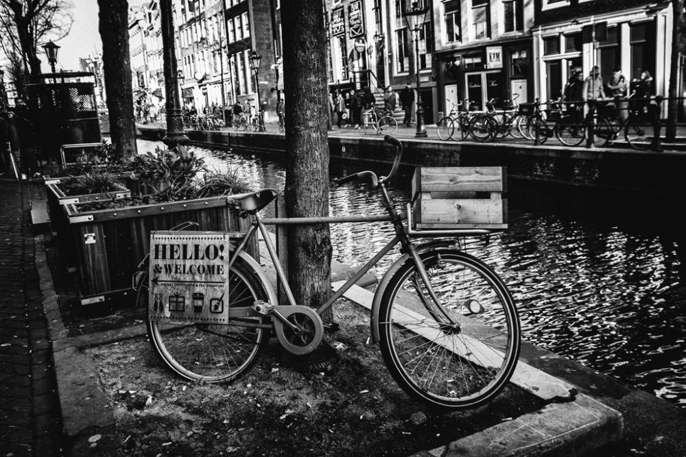 AMSTERDAM, NETHERLANDS - February 2016 - The lanes along side the canals and whistling bicycles welcome you in Red Light District