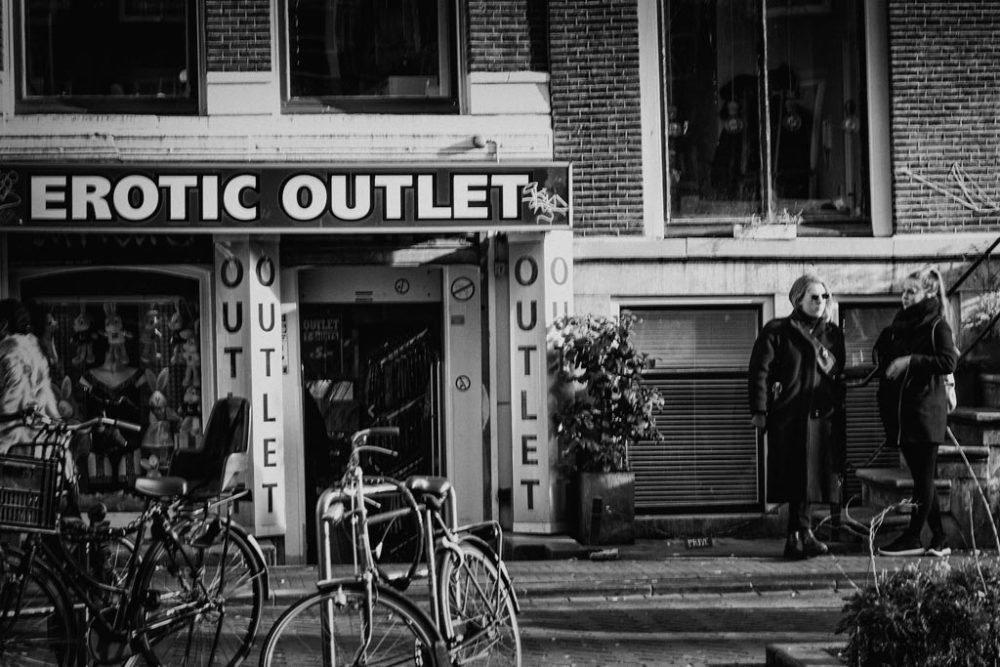 AMSTERDAM, NETHERLANDS - February 2016 - Ladies chatting and having fun in front of an erotic toy shop