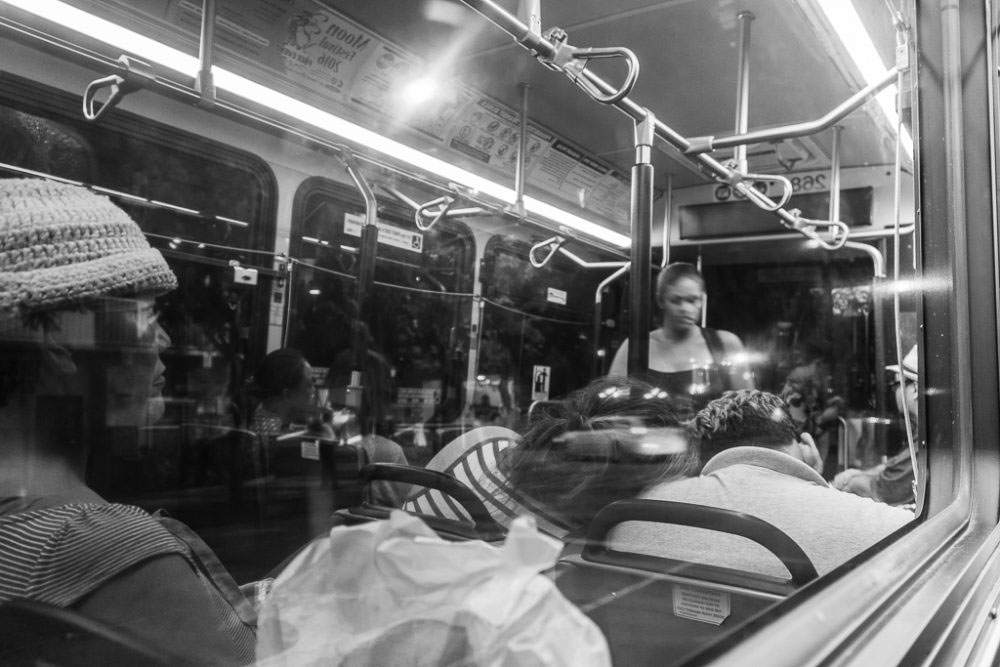 Honolulu, Hawaii - August, 2016. The most common scenario in the public bus is sleep. Sometimes they lean on the person whom they even don't know! In this case, I caught the reflection of a couple who was sleeping, leaning on each other with a touch of caring and love.