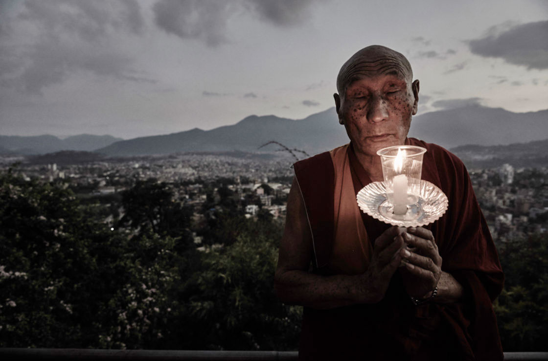 Buddhist monk praying for the deceased and survivors of the earthquakes.