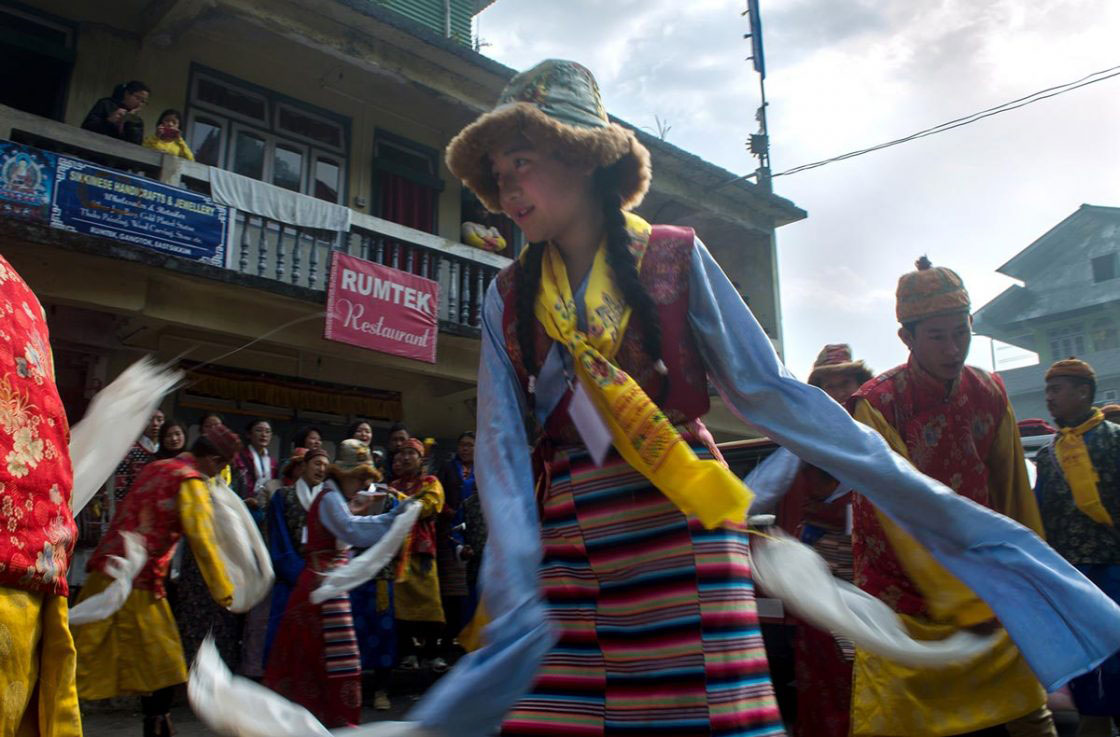 Sikkim, India- December 2015. Group of traditionally dressed "Bhutia" performer is celebrating "Lawsung" by Dancing and Singing in front of Rumtek Monastery.