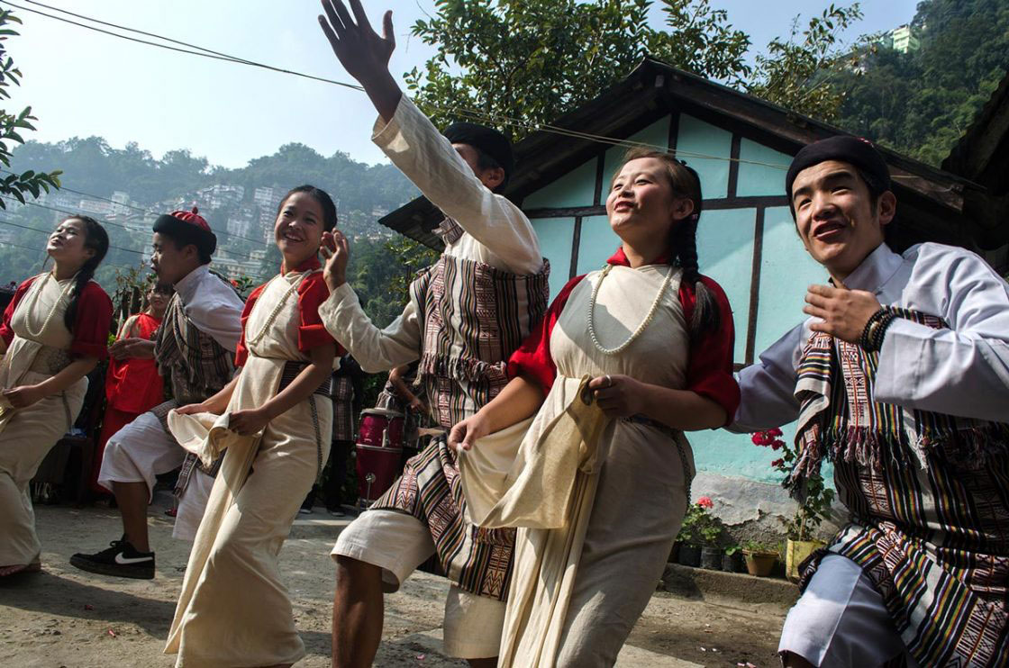 Sikkim, India- December 2015. Group of "Lepcha" performer dressed traditionally dancing with traditional song at Sehri Kopibari. Thanks giving festival "Namsung" is celebrated mostly with family members and friends, a performing group goes house to house to show their charisma on traditional song and dance. House lord gives them Tea, sweet snacks "Zeroo", "Kabje", "Paumulangcho" and some gifts mainly money.