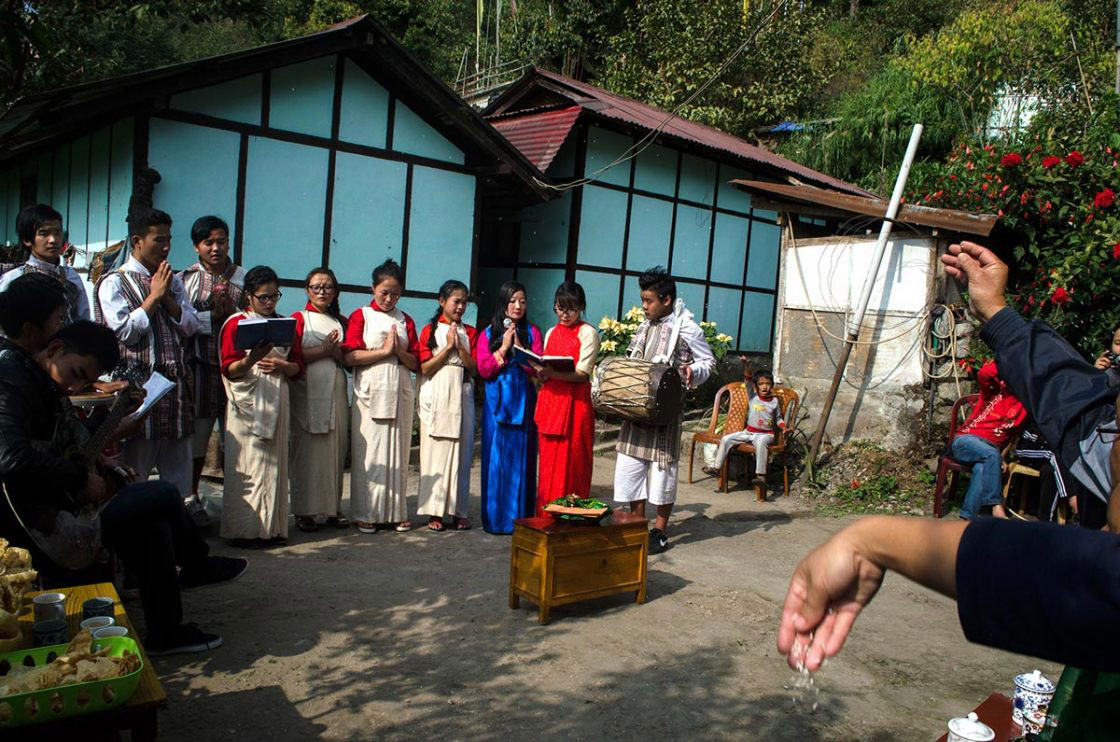 Sikkim, India- December 2015. Audience throws new paddy grain on Lepcha performer at Sehri Kopibari. Welcome upcoming year and thanks giving festival "Namsung" traditional performance always ends with the prayer and well-wishes for the house and community, this last song sung by performer accomplice with traditional instrument "Tungdarbong", "Timbuk", "Tungdar" and Guitar, audience also uplift their voice with performer, to welcome gods bless they throws new grain.